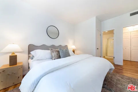 a bed room with a bed and mirror