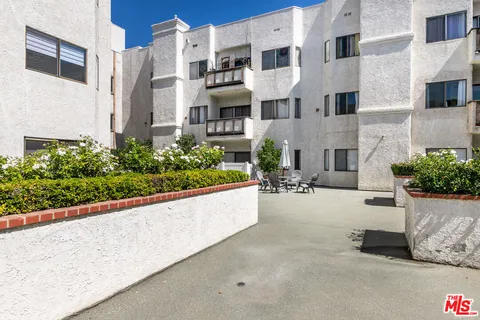 a view of a building with potted plants