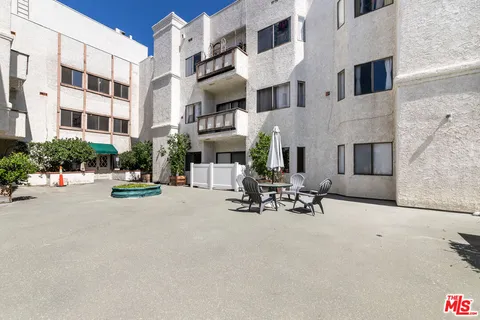 a row of building with sitting area in front of it