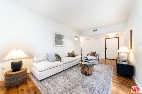 a living room with furniture and a lamp