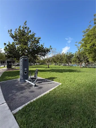 a view of a park with a house in the background