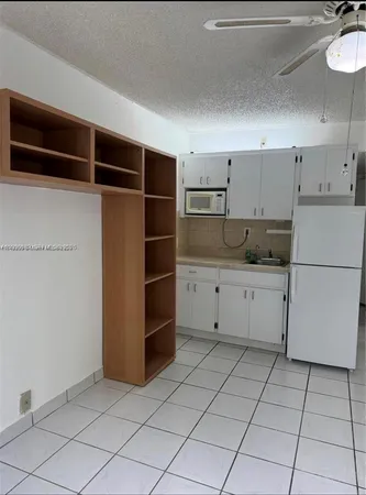 a kitchen with cabinets and appliances