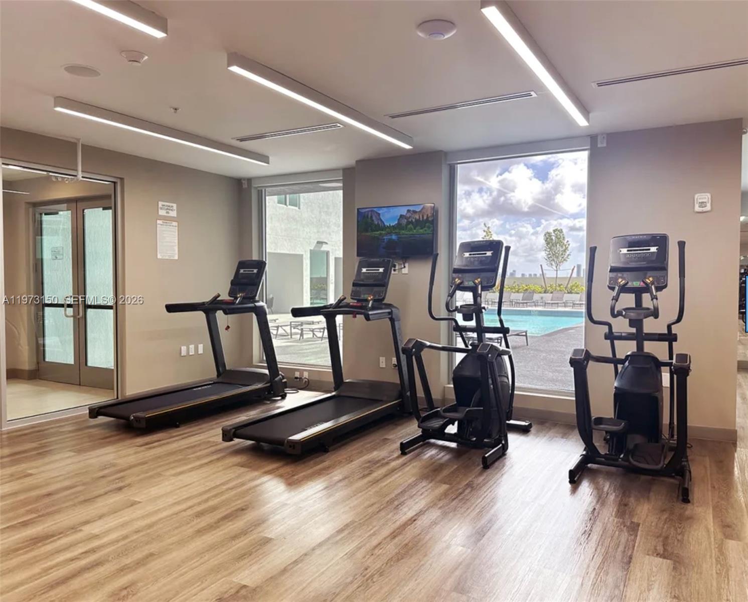 61 Northwest 37th Avenue, Unit 414 Miami, FL 33125 - Photo 13 of 18 a view of a room with gym equipment