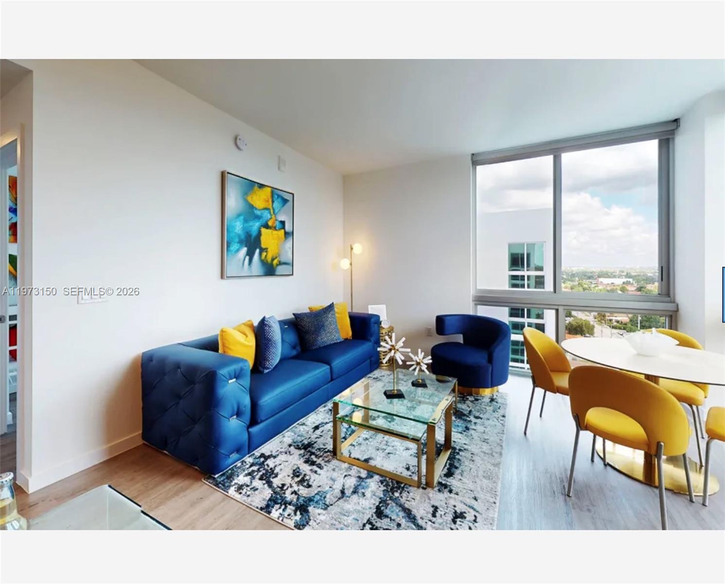 61 Northwest 37th Avenue, Unit 414 Miami, FL 33125 - Photo 14 of 18 a living room with furniture and a large window