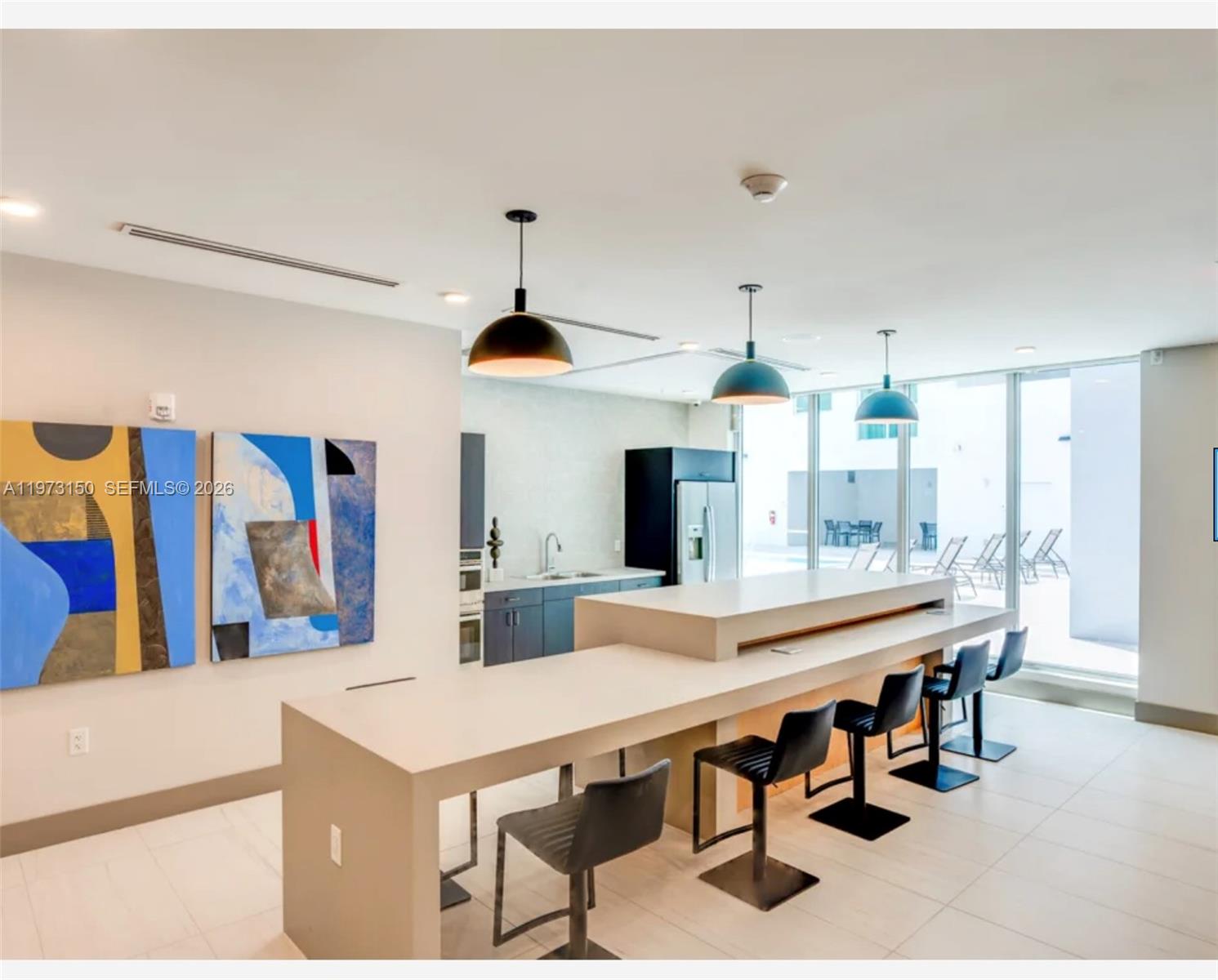 61 Northwest 37th Avenue, Unit 414 Miami, FL 33125 - Photo 16 of 18 a large kitchen with a table and chairs