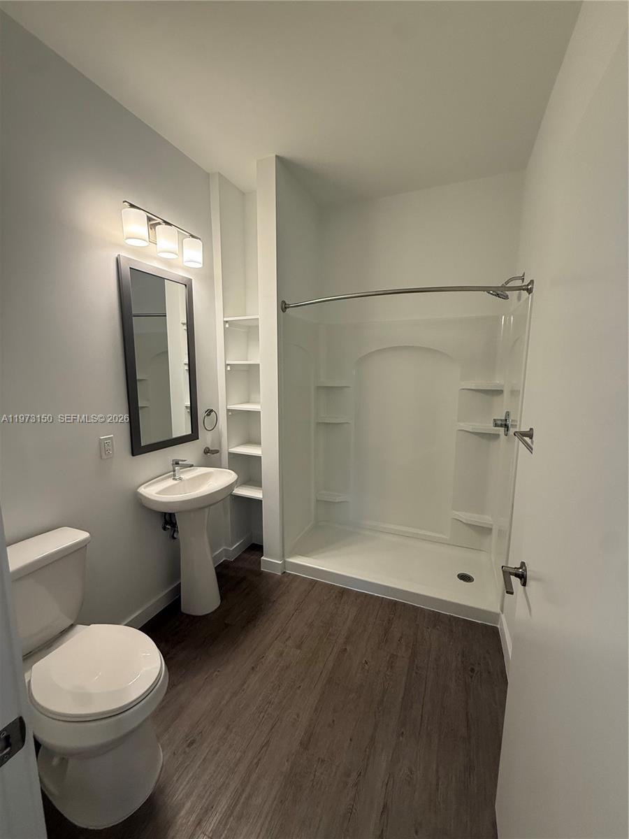 61 Northwest 37th Avenue, Unit 414 Miami, FL 33125 - Photo 7 of 18 a bathroom with a sink toilet and shower
