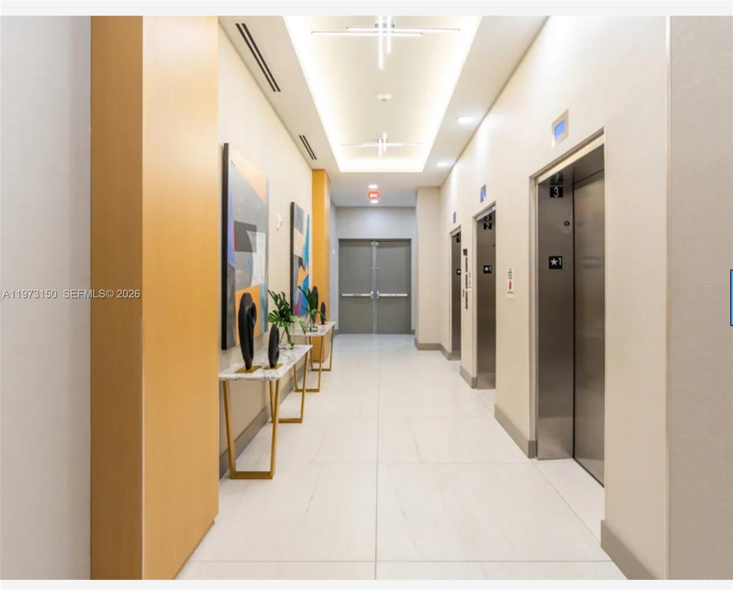 61 Northwest 37th Avenue, Unit 414 Miami, FL 33125 - Photo 10 of 18 a view of a hallway with potted plants