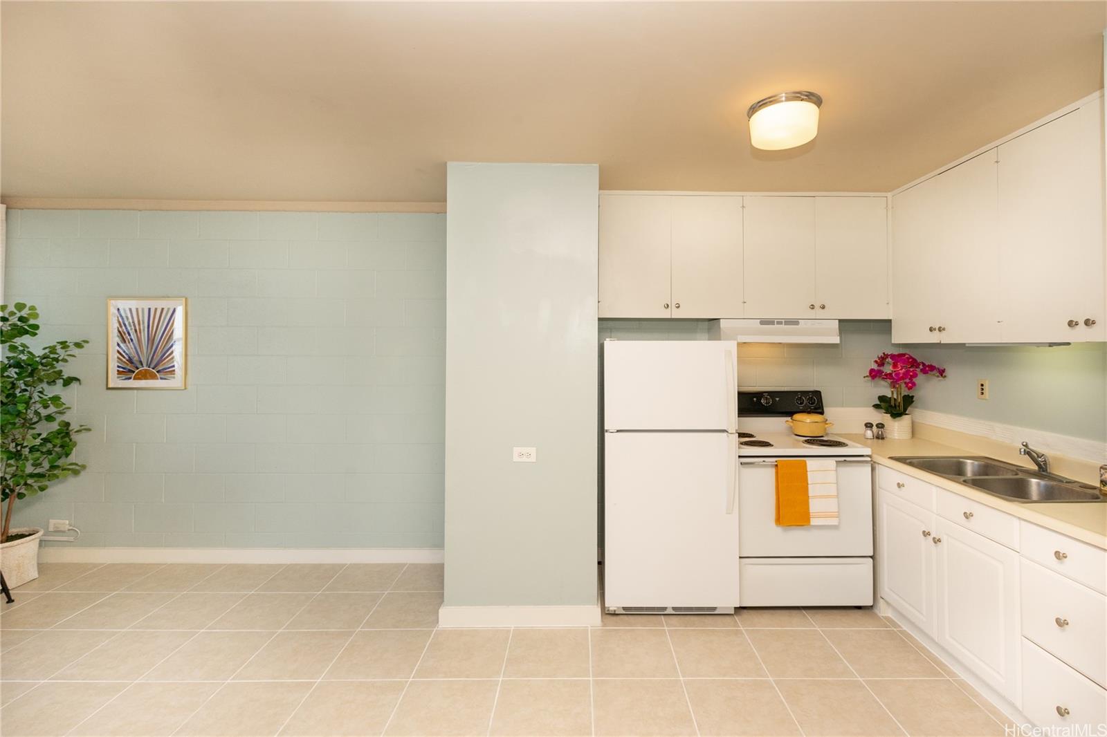 98-135 Lipoa Place, Unit 301 Aiea, HI 96701 - Photo 8 of 17 a white refrigerator freezer sitting inside of a kitchen