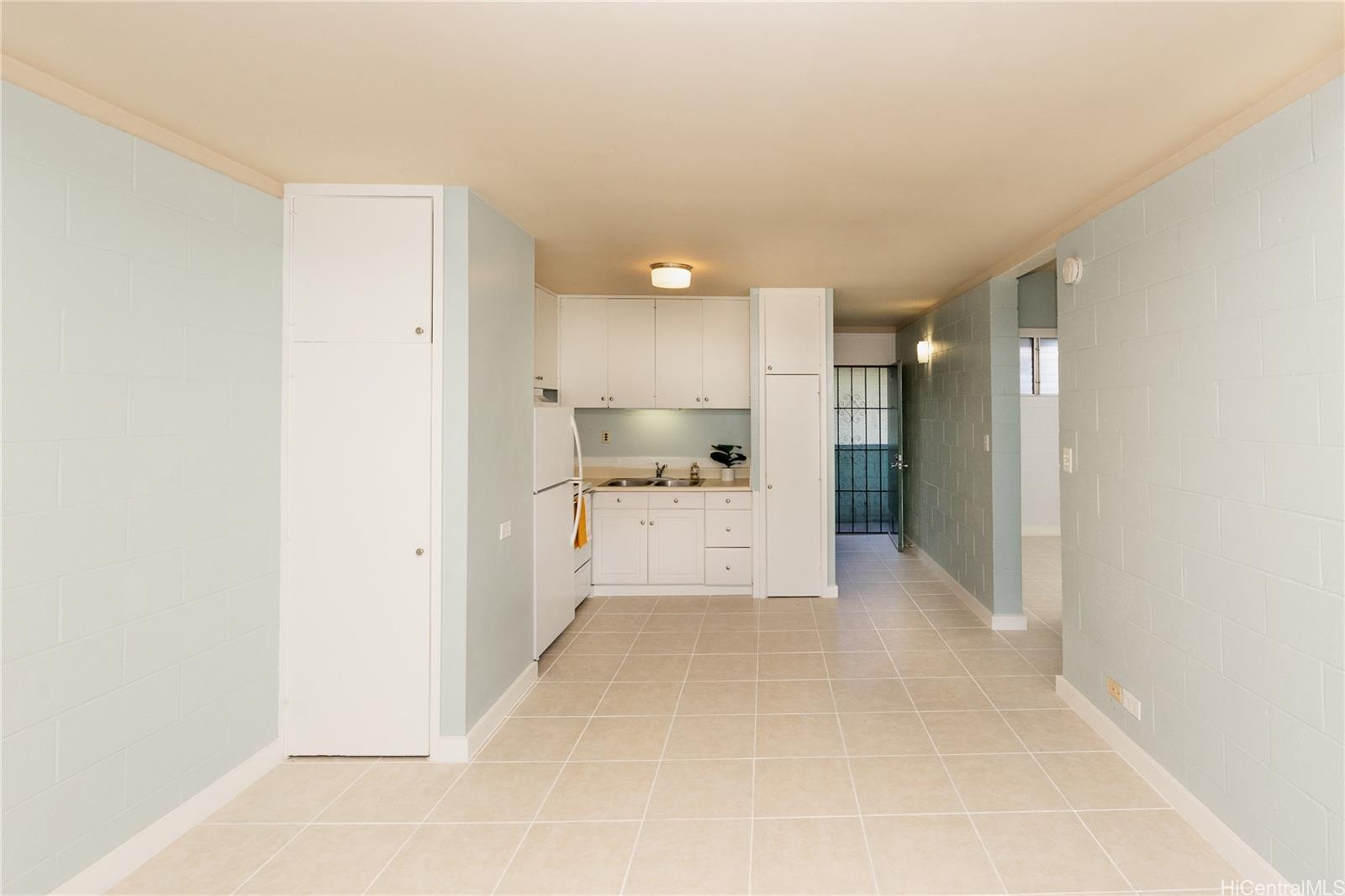 98-135 Lipoa Place, Unit 301 Aiea, HI 96701 - Photo 9 of 17 a view of a kitchen with refrigerator and a sink