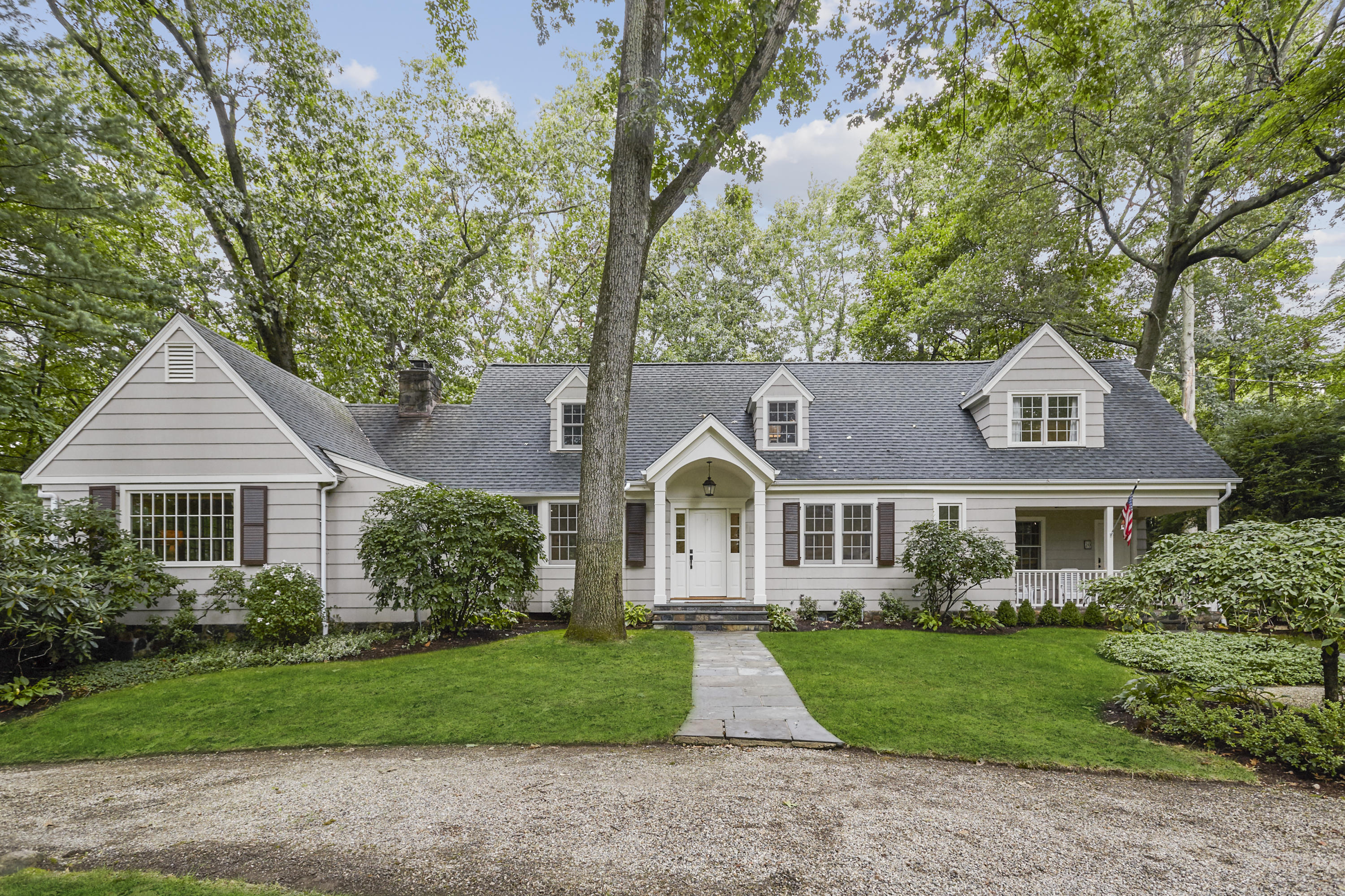 20 Homestead Road Darien, CT 06820 - Photo 1 of 48 a front view of a house with a garden and trees