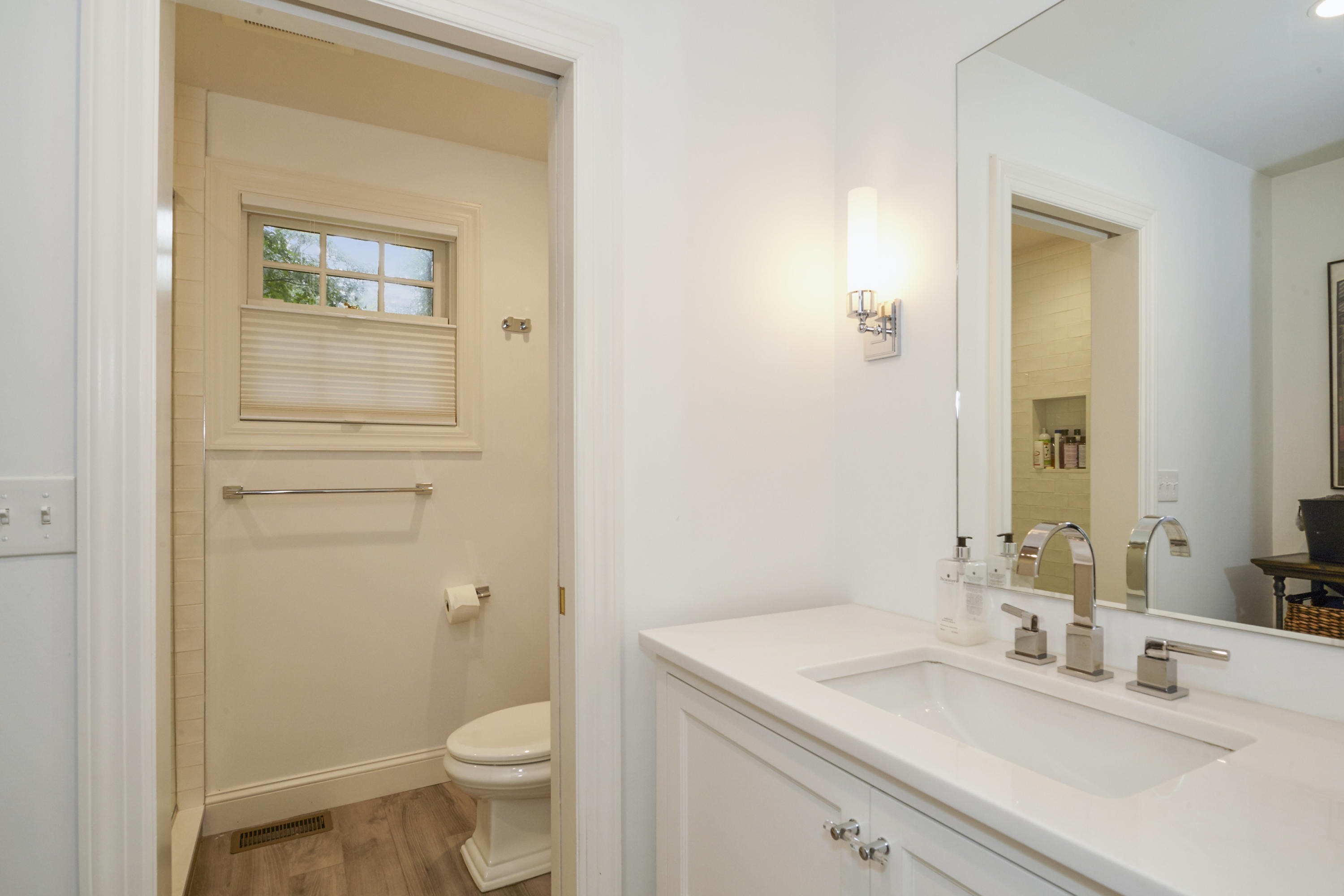 20 Homestead Road Darien, CT 06820 - Photo 27 of 48 a bathroom with a granite countertop toilet a sink and a mirror