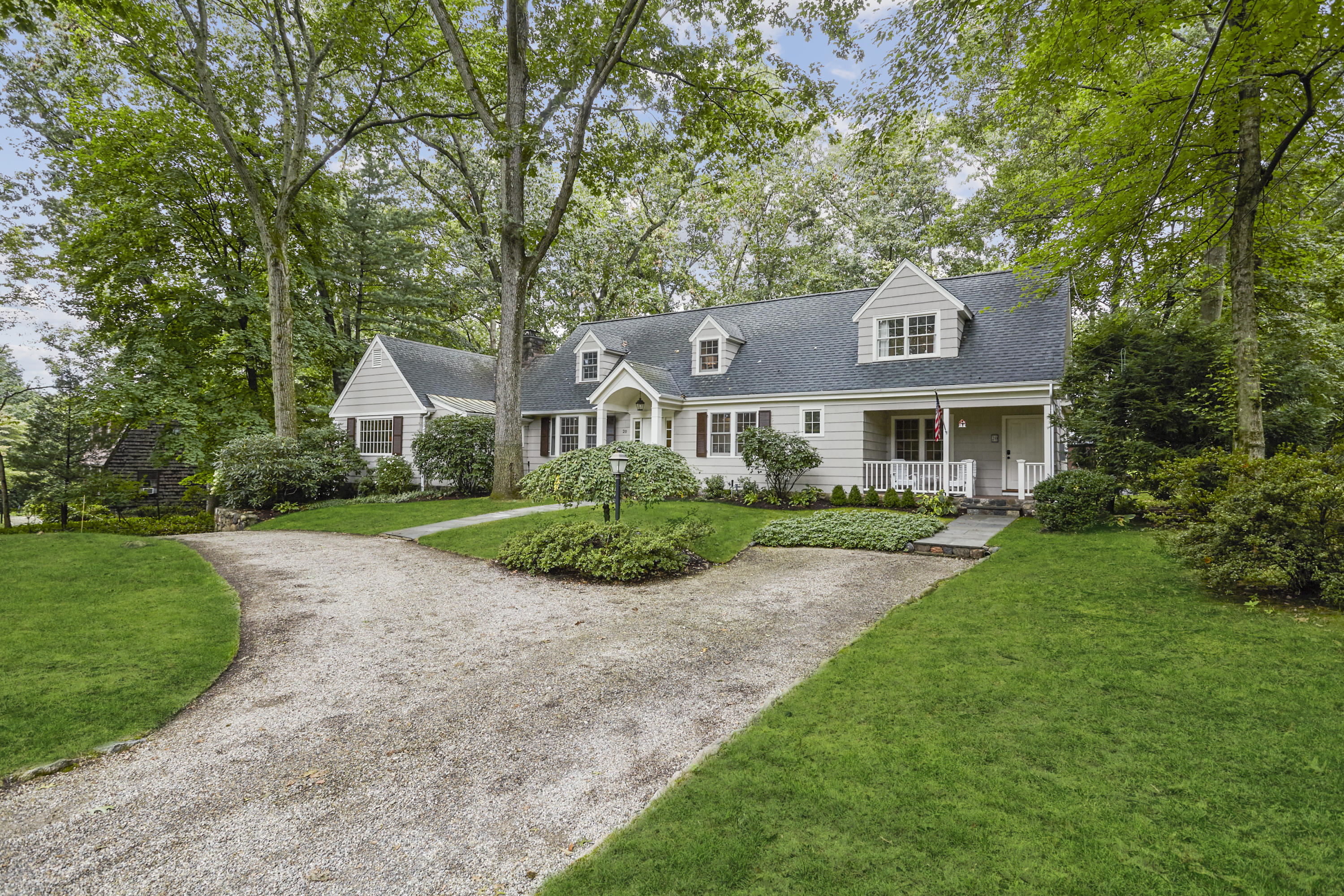 20 Homestead Road Darien, CT 06820 - Photo 3 of 48 a front view of a house with a yard and trees