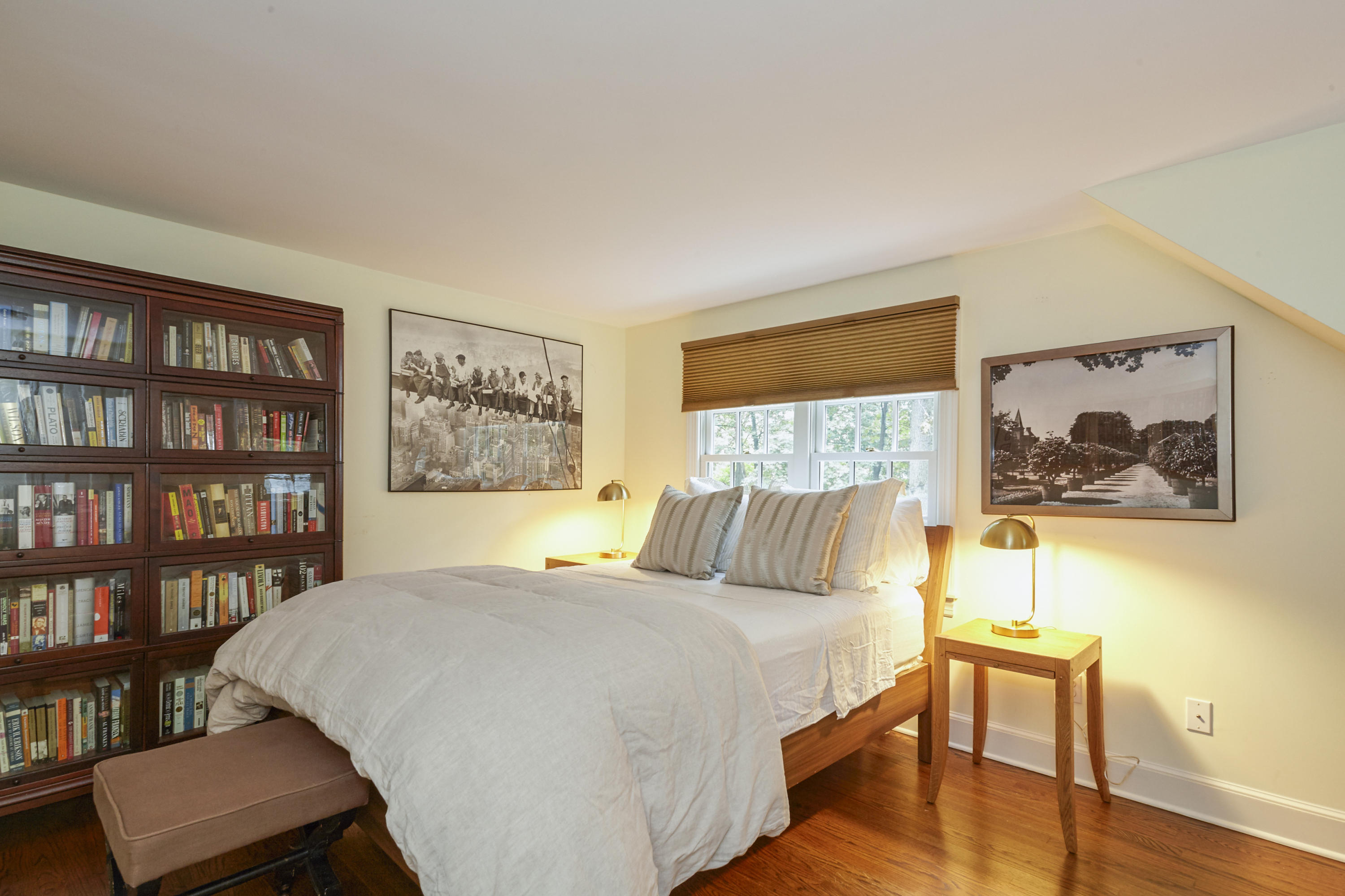 20 Homestead Road Darien, CT 06820 - Photo 34 of 48 a bedroom with a bed and a bookshelf with wooden floor