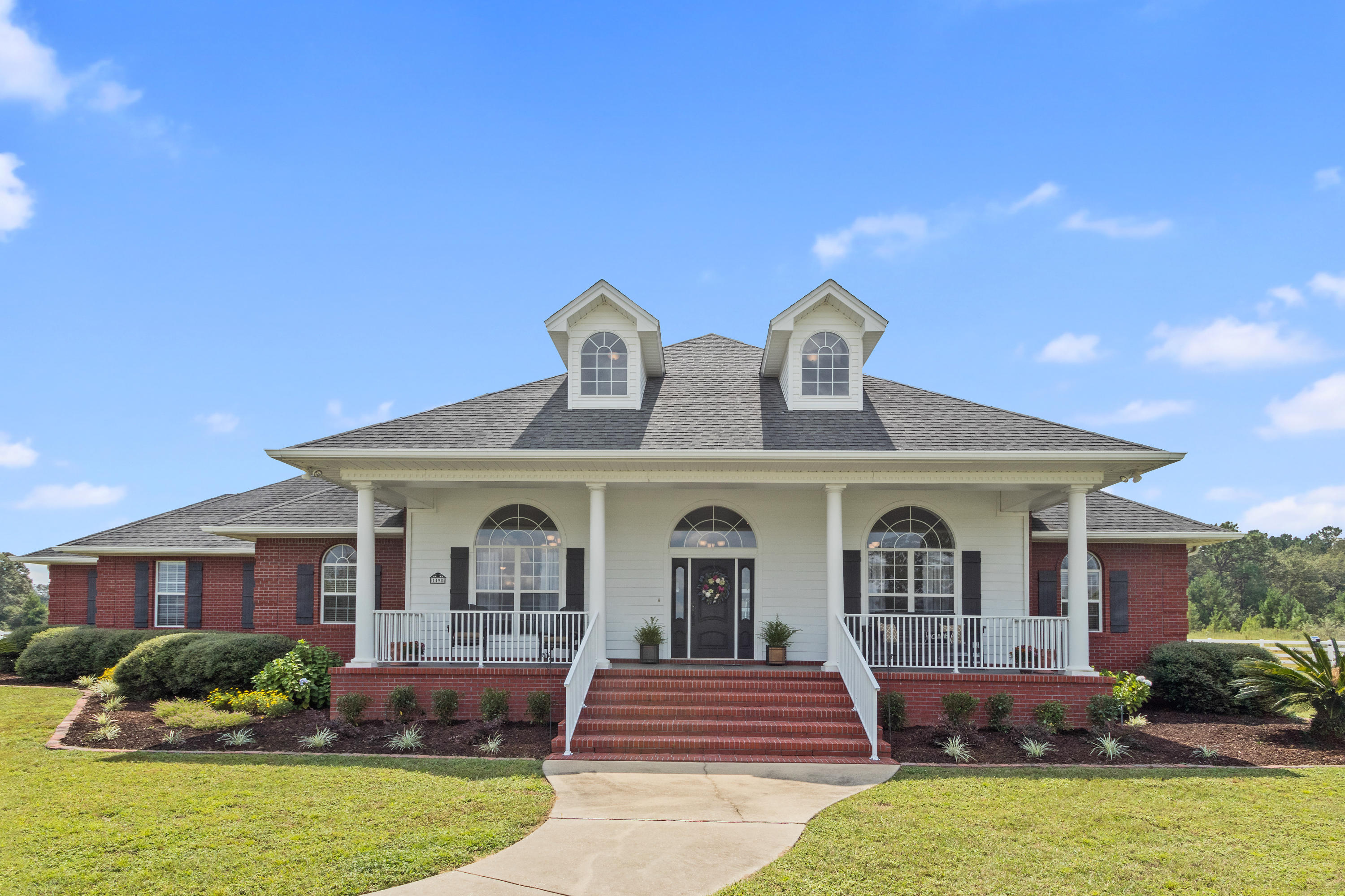 1498 Sky Ranch Lane Baker, FL 32531 - Photo 2 of 86 a front view of a house with garden