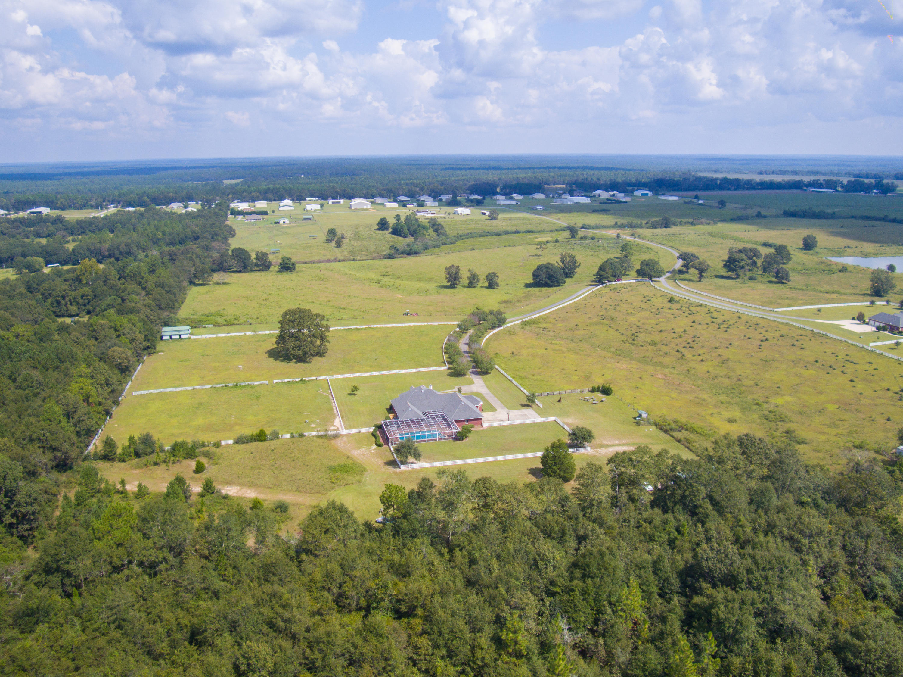 1498 Sky Ranch Lane Baker, FL 32531 - Photo 16 of 86 a view of a swimming pool with a table under an umbrella