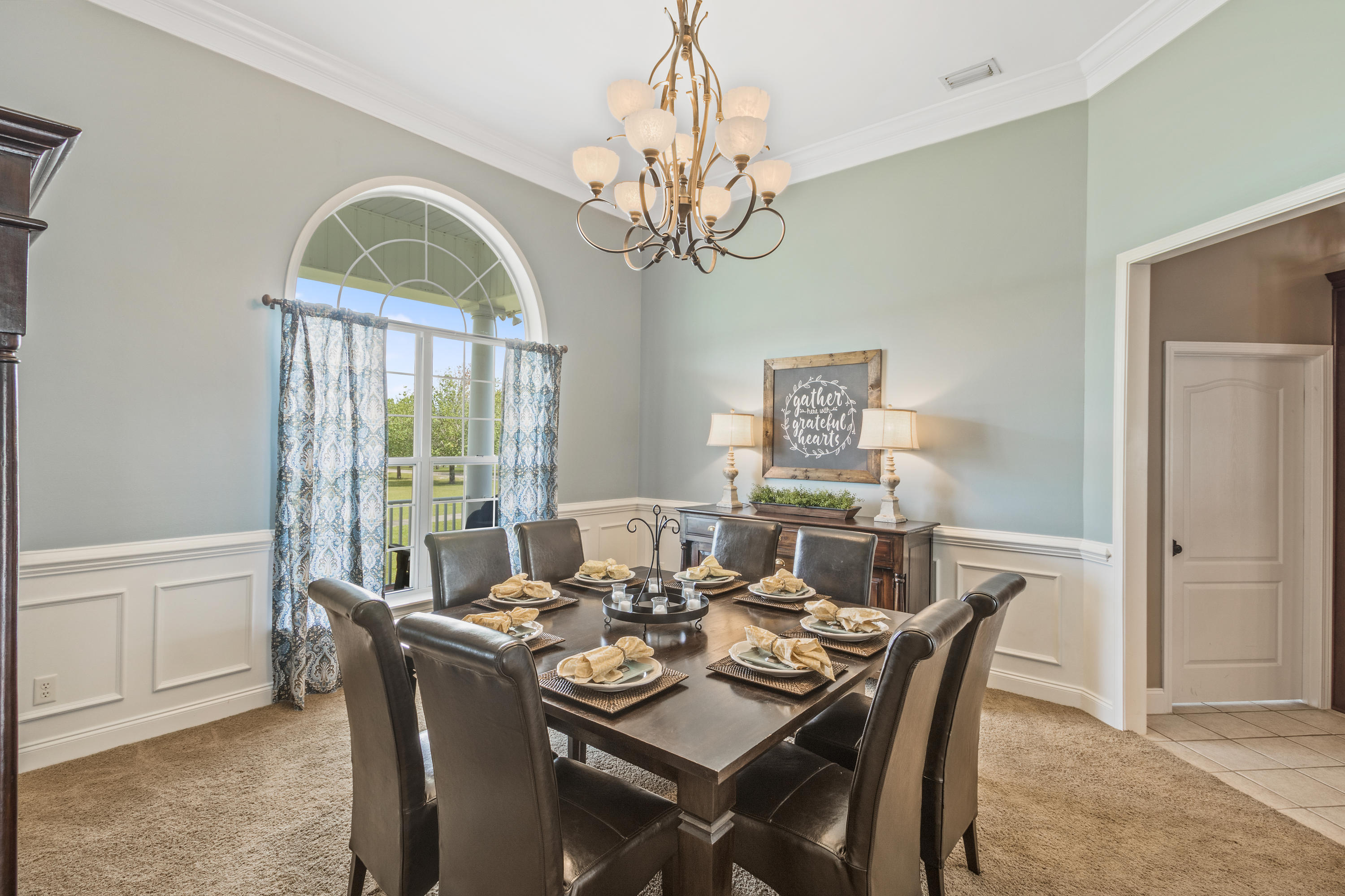 1498 Sky Ranch Lane Baker, FL 32531 - Photo 18 of 86 a view of a dining room with furniture a chandelier and wooden floor