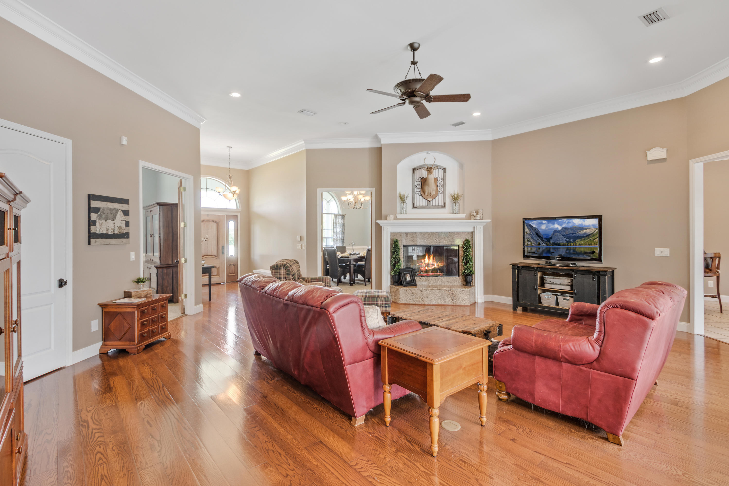 1498 Sky Ranch Lane Baker, FL 32531 - Photo 21 of 86 a living room with fireplace furniture and a wooden floor