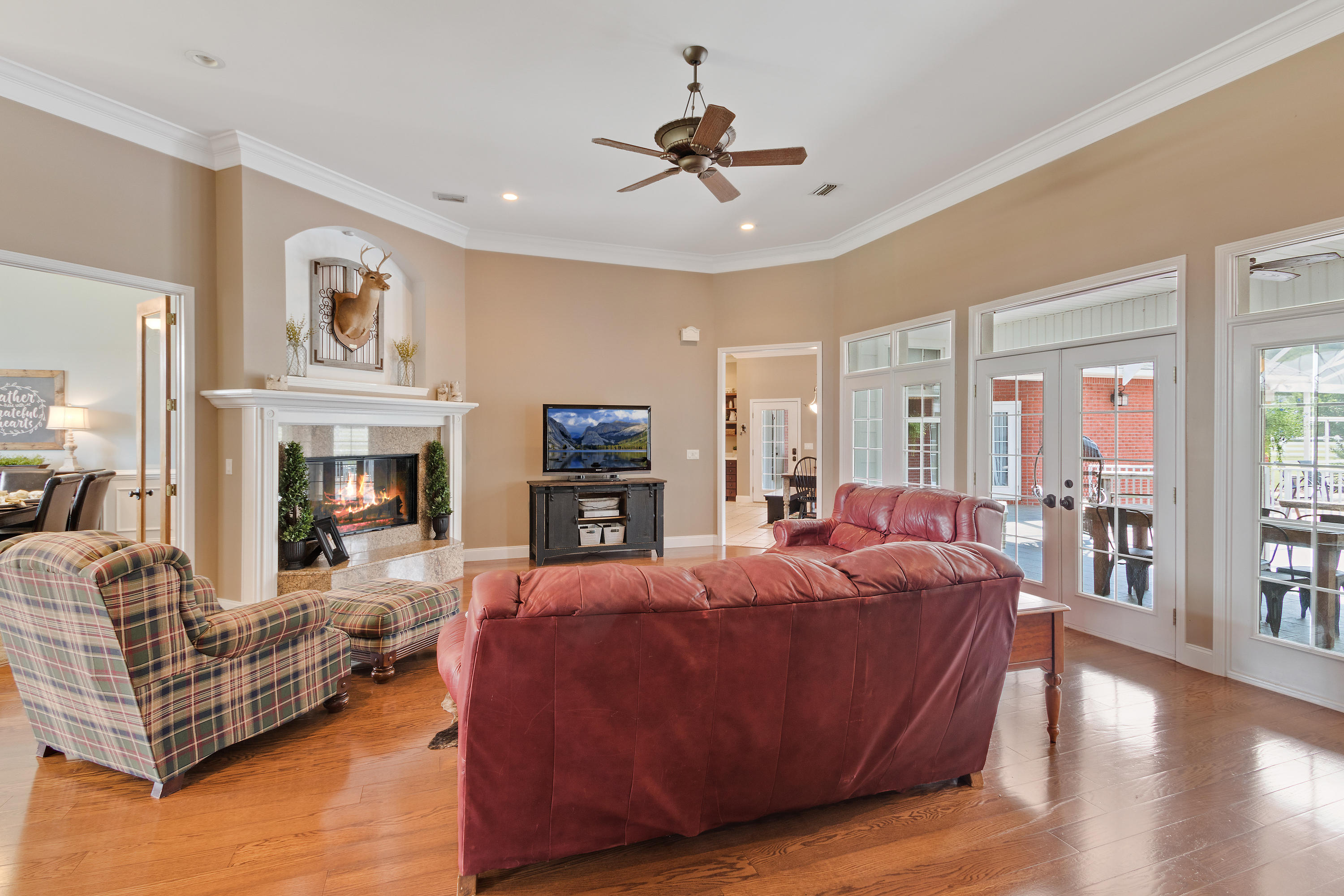 1498 Sky Ranch Lane Baker, FL 32531 - Photo 22 of 86 a living room with furniture a fireplace and a chandelier
