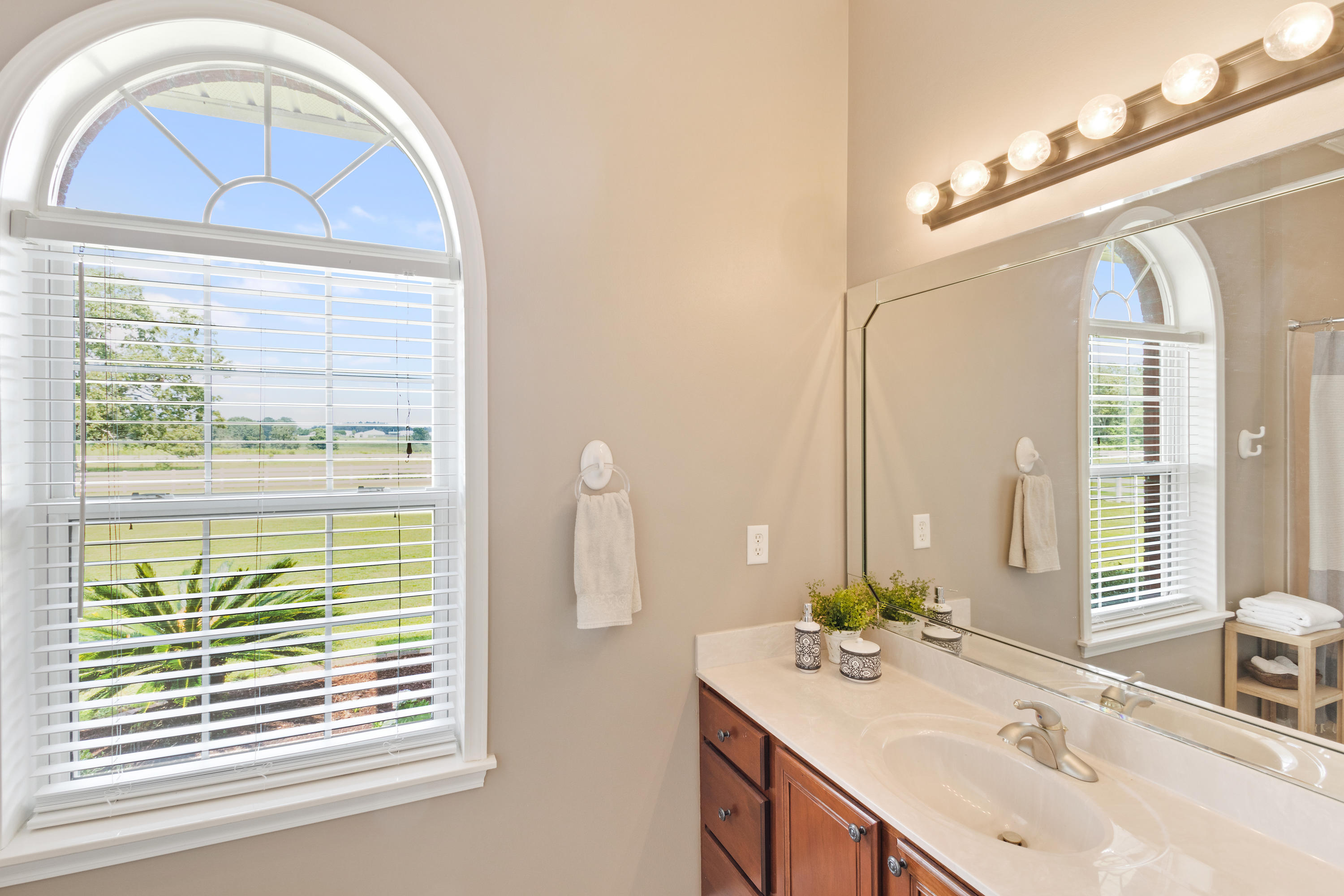 1498 Sky Ranch Lane Baker, FL 32531 - Photo 42 of 86 a bathroom with a sink and a mirror