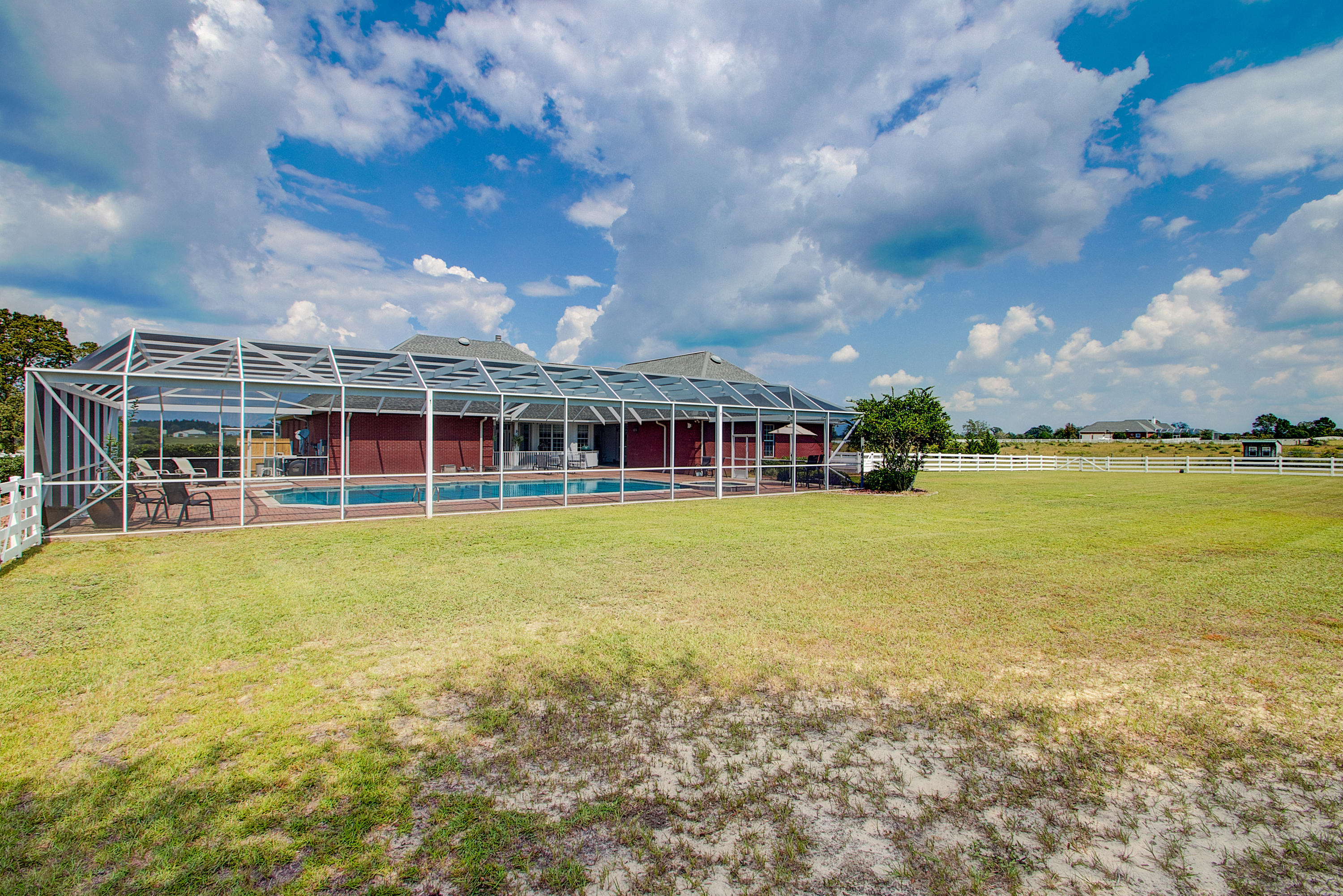 1498 Sky Ranch Lane Baker, FL 32531 - Photo 68 of 86 a view of a house with a swimming pool and a yard