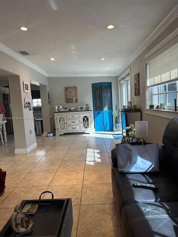 a large kitchen with lots of counter space and furniture