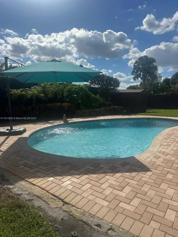 a view of swimming pool with a yard