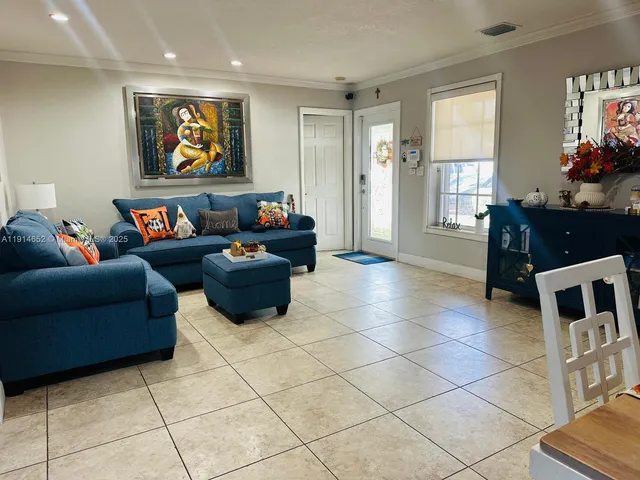 a living room with furniture and a flat screen tv