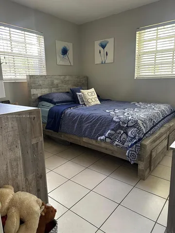 a bedroom with a bed and a window in it