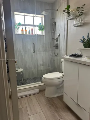 a bathroom with a toilet a sink and shower
