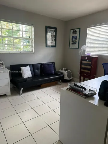 a living room with a couch and a window