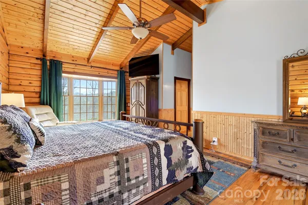a bed sitting in a bedroom next to a window