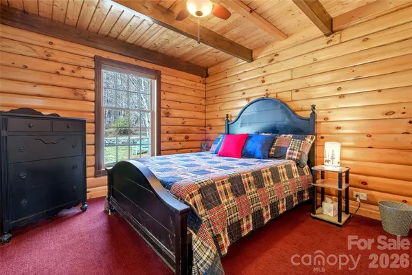 a bed sitting in a bedroom next to a window
