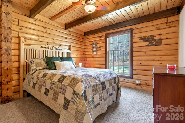 a bedroom with a bed next to a window