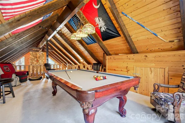 a room with pool table and glass windows