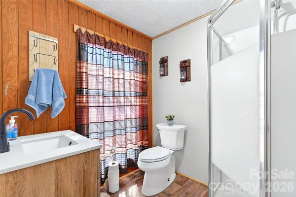 a bathroom with a toilet sink and shower