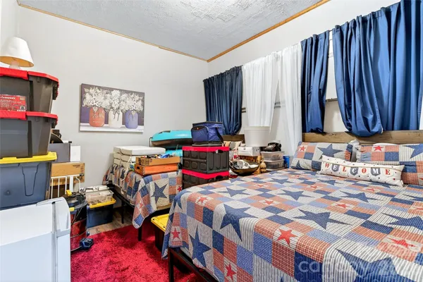 a bedroom with a bed and a furniture
