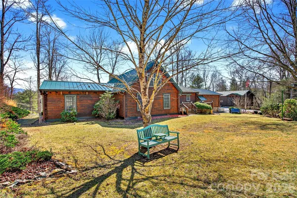 a front view of house with yard and trees around