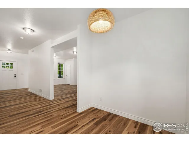 a view of an empty room and wooden floor