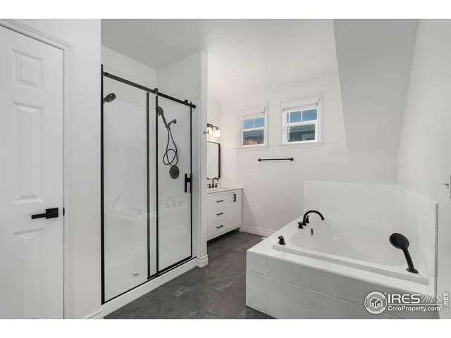 a bathroom with a bathtub and a shower