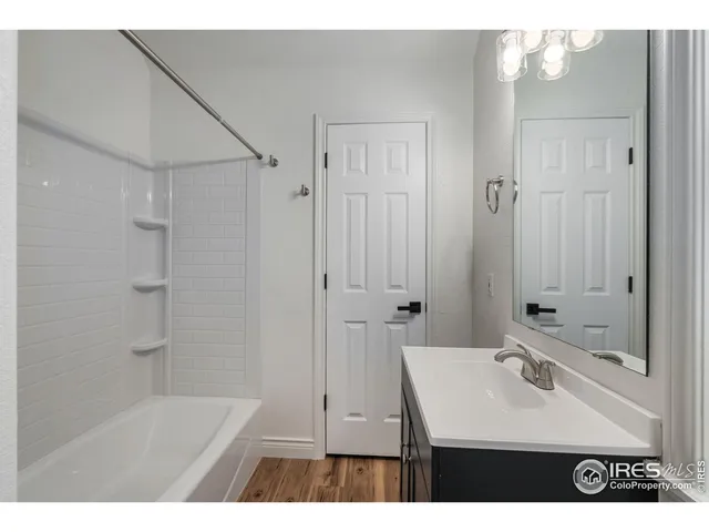a bathroom with a sink a mirror and a shower