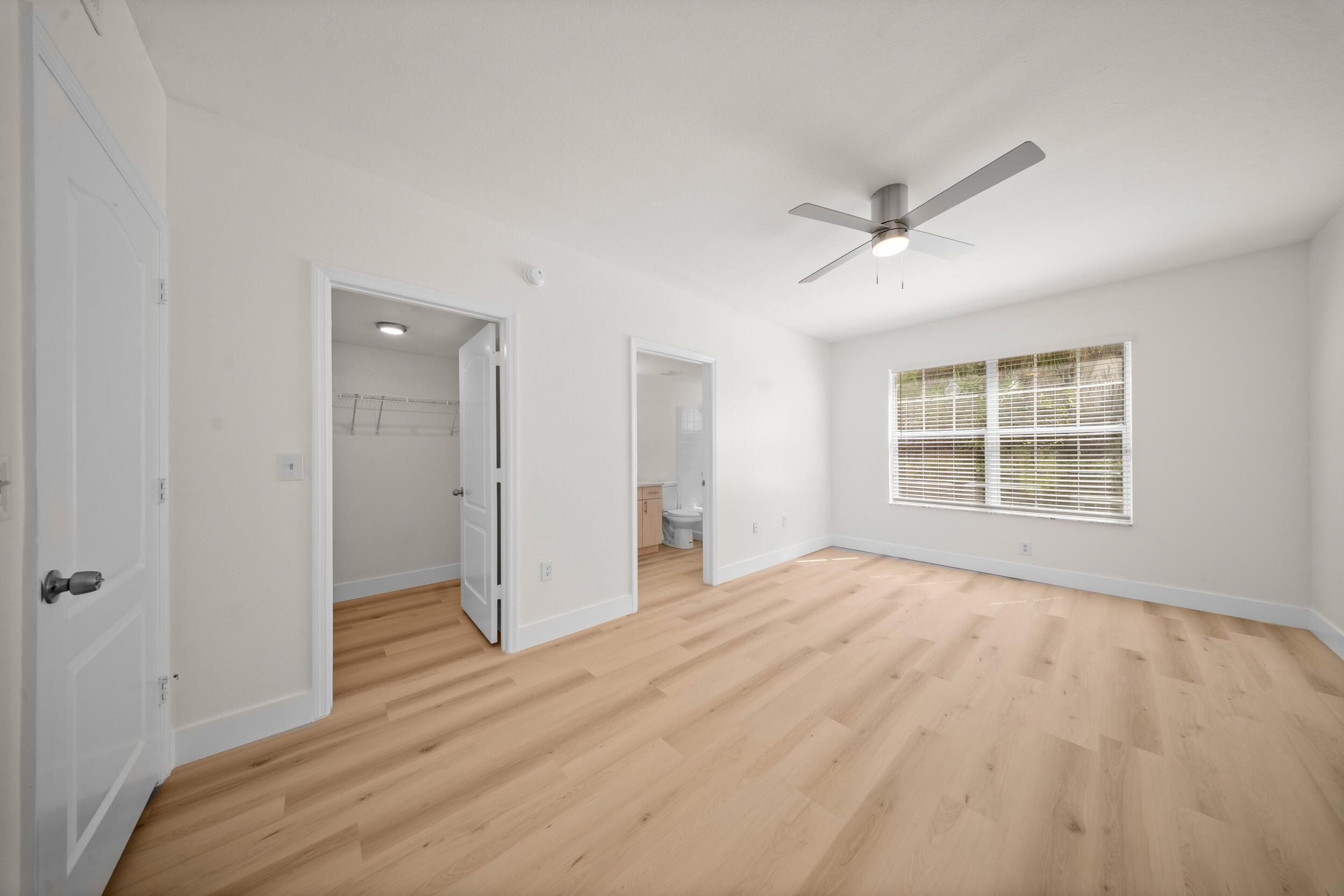 110 Southwest Peacock Boulevard, Unit 6102 Port St. Lucie, FL 34986 - Photo 17 of 40 a view of empty room with wooden floor and fan