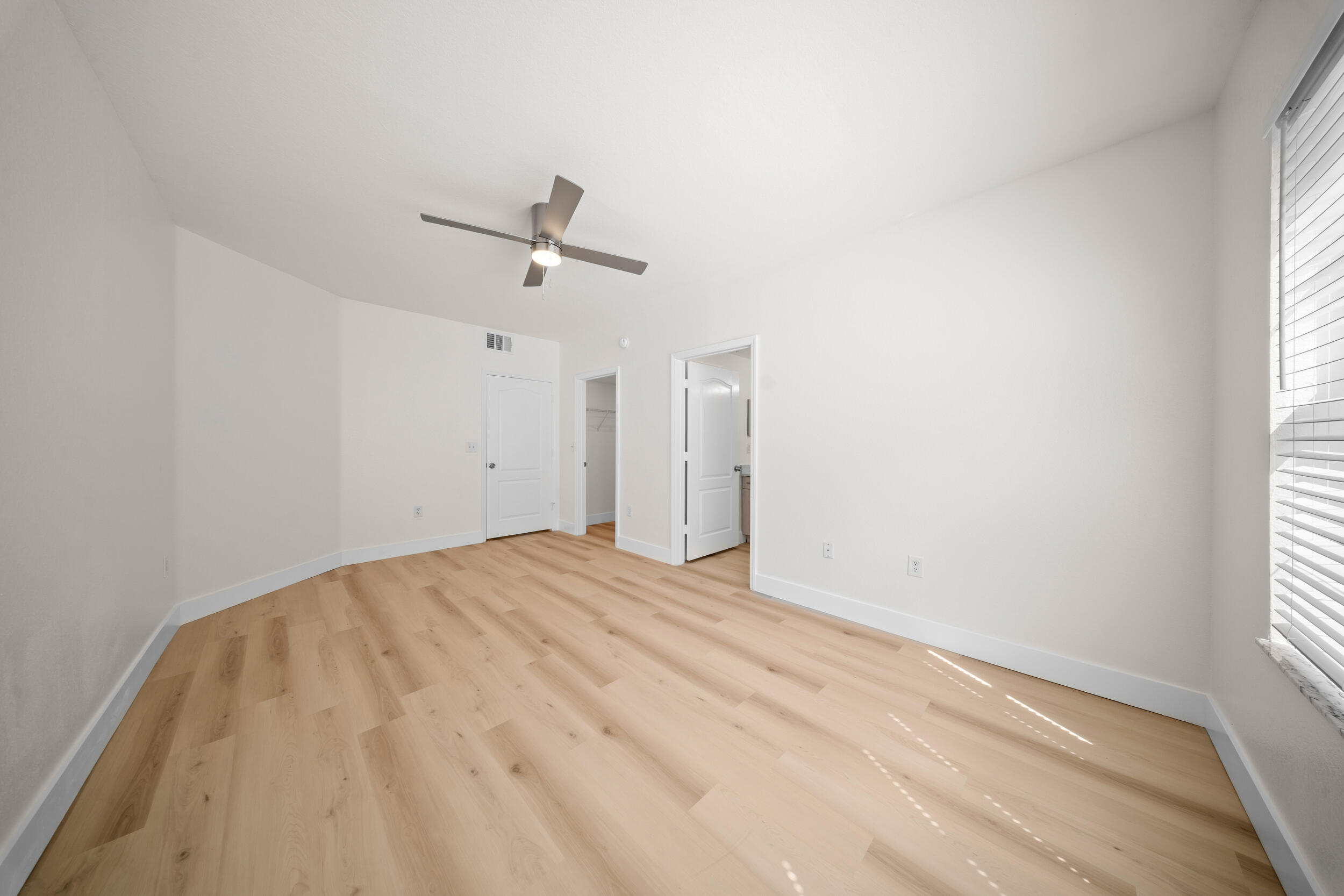 110 Southwest Peacock Boulevard, Unit 6102 Port St. Lucie, FL 34986 - Photo 18 of 40 a view of a room with a ceiling fan and a window