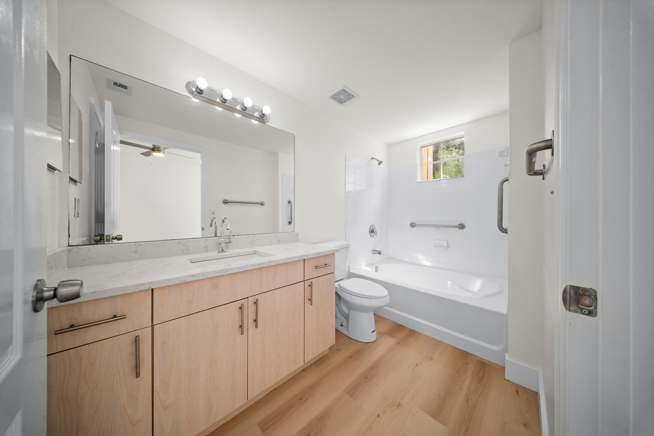 110 Southwest Peacock Boulevard, Unit 6102 Port St. Lucie, FL 34986 - Photo 19 of 40 a bathroom with a granite countertop sink mirror and toilet