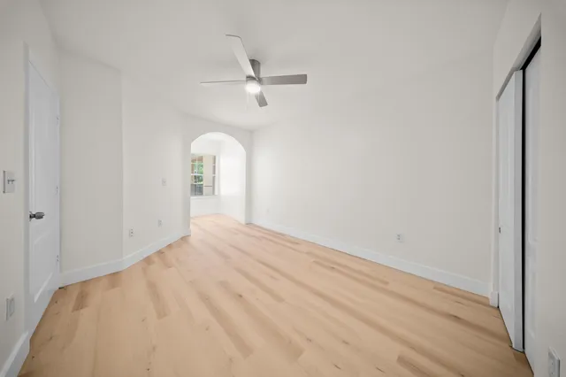 a view of a big room with closet and windows