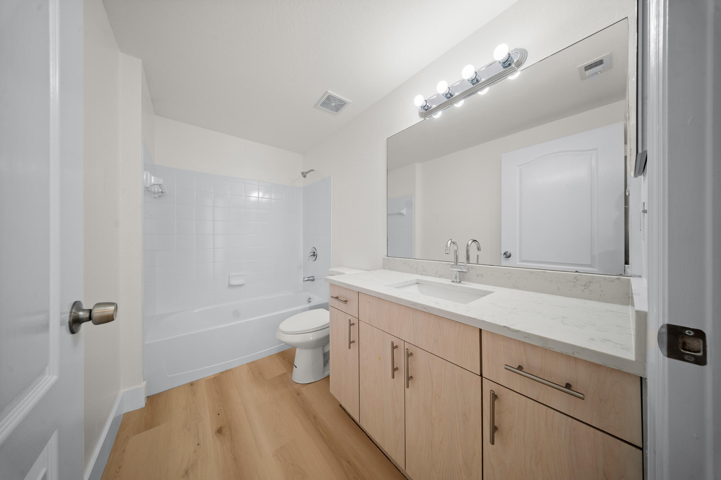 110 Southwest Peacock Boulevard, Unit 6102 Port St. Lucie, FL 34986 - Photo 25 of 40 a bathroom with a sink a toilet a mirror and vanity