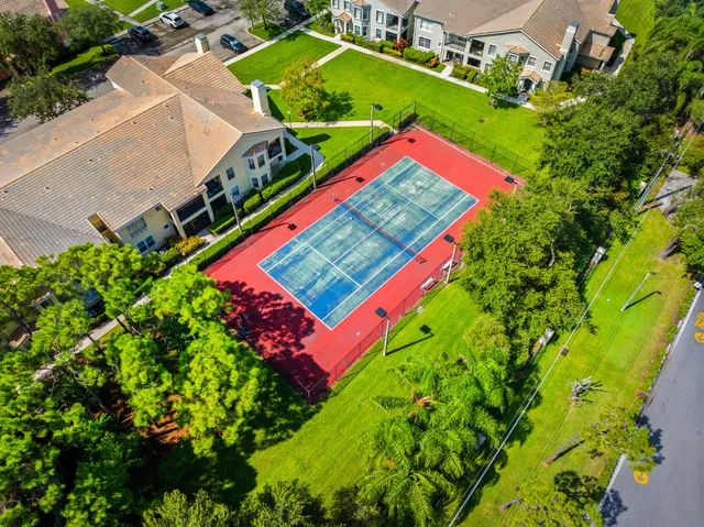 an aerial view of a tennis ground with large trees