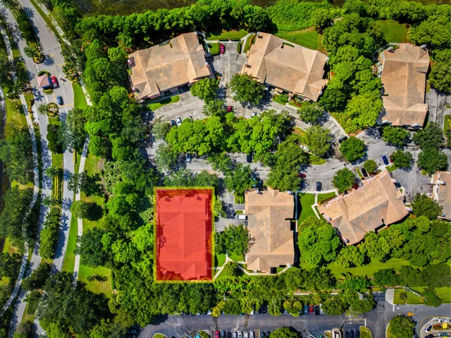 an aerial view of a house with a yard and trees