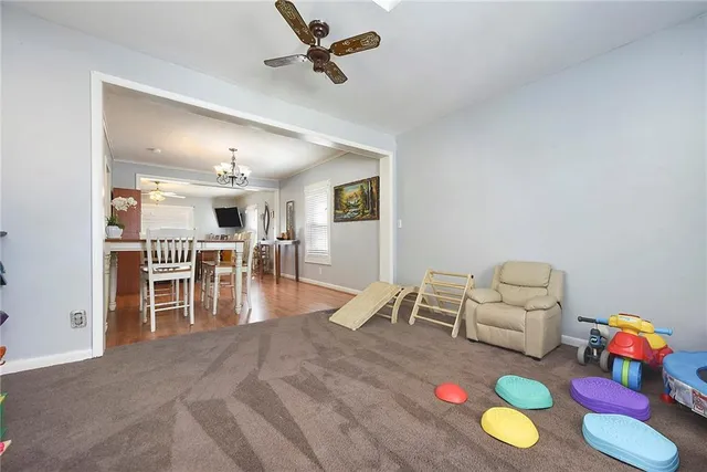 a living room with furniture and kitchen view