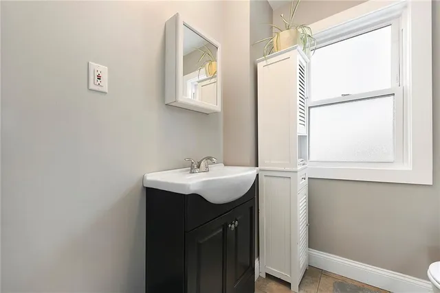 a bathroom with a sink a mirror and a toilet