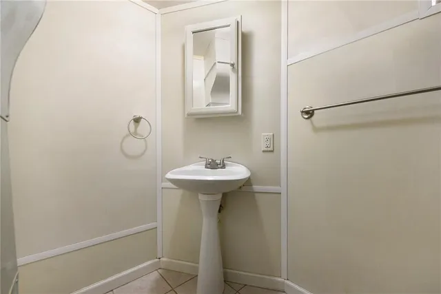 a bathroom with a sink a mirror and shower